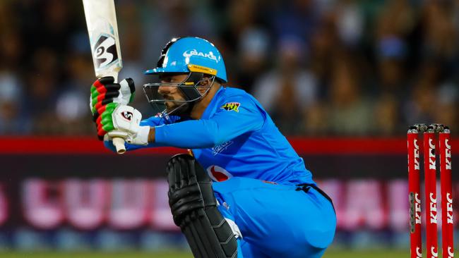 CRACKING SHOT: Striker Rashid Khan thumps a boundary during his near-matchwinning innings against the Sydney Thunder on New Year’s Eve. Picture: Daniel Kalisz/Getty Images