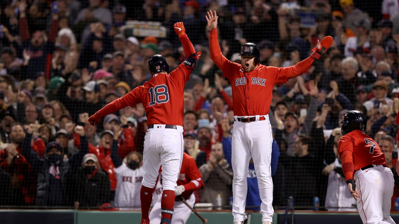 BOSTON, MASSACHUSETTS - OCTOBER 18: Kyle Schwarber #18 of the Boston Red Sox celebrates with Christian Arroyo #39 after Schwarber hit a grand slam home run against the Houston Astros in the second inning of Game Three of the American League Championship Series at Fenway Park on October 18, 2021 in Boston, Massachusetts. (Photo by Elsa/Getty Images)