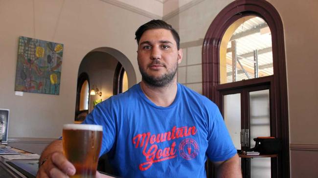 Manager and hotel owner Darren Pettiford at the Warwick Hotel with a schooner of beer in hand. Picture: Marian Faa