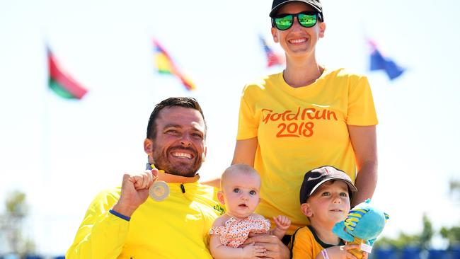 Kurt Fearnley with wife Sheridan, son Harry and daughter Emilia after his gold medal in the T54 marathon at the Gold Coast 2018 Commonwealth Games. Picture: Matt Roberts/Getty Images