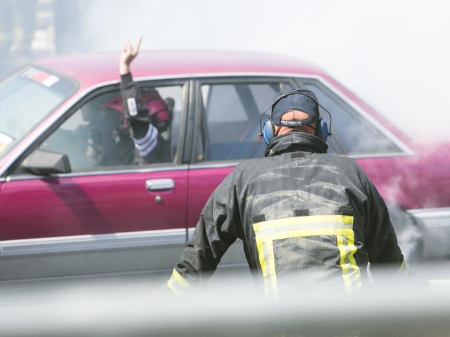 SUNDAY TELEGRAPH SPECIAL. A fire fighter watches on during a burnout during Summernats 31 2018. Photo: Keegan Carroll