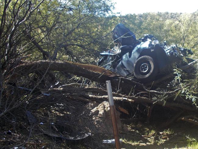 In this Oct. 18, 2018, photo provided by the Arizona Department of Public Safety is the scene where authorities say they rescued a seriously injured woman who spent six days in the desert after crashing her car near Wickenburg, Ariz. The Department of Public Safety said Wednesday, Oct. 31, 2018, that rescuers found the severely dehydrated 53-year-old woman on Oct. 18 after following the vehicle's tracks. A maintenance crew and a rancher spotted the car while working along a highway several miles from the historic Western town of Wickenburg. (Arizona Department of Public Safety via AP)