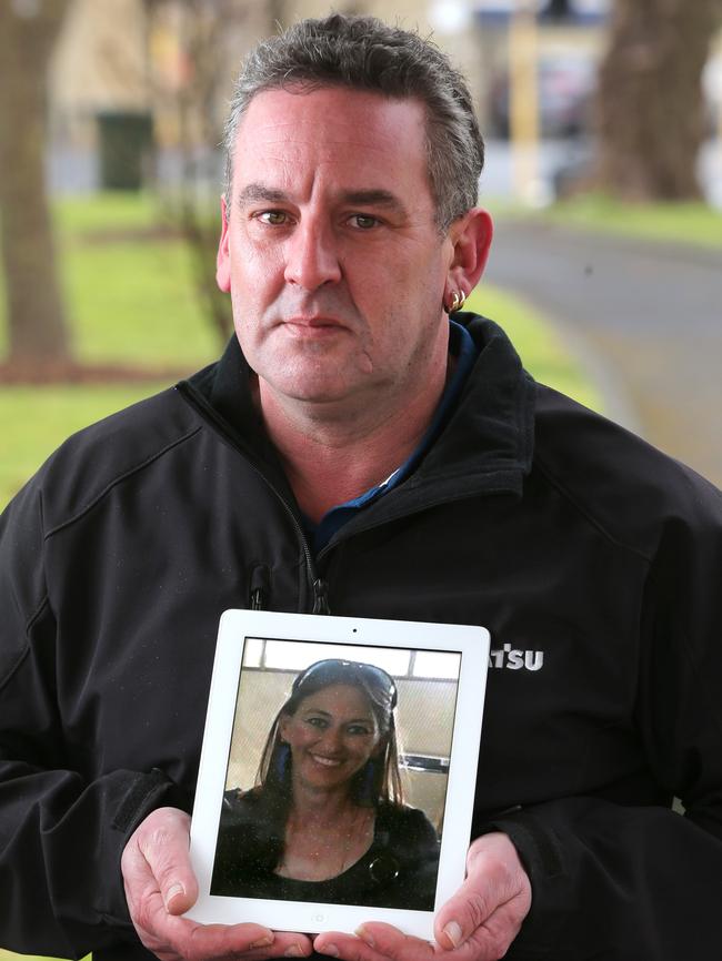 Anthony Santuccione holding a photo of his partner. Picture: Mike Dugdale