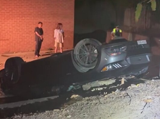 A luxury car crashed through a fence and flipped in Kellyville. Picture: Facebook