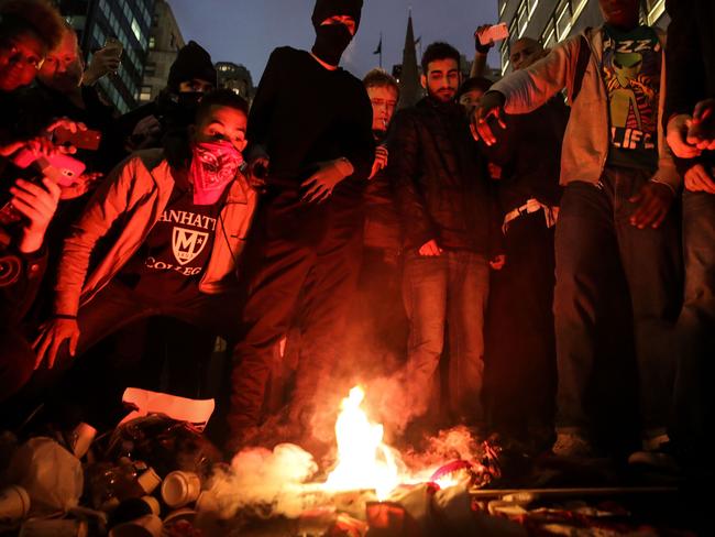 Protestors burn an American flag on Fifth Avenue outside of Trump Tower, November 9, 2016 in New York City. Picture: AFP