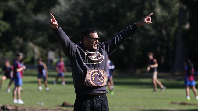 Justin Hodges rewards Indigenous students for going to school with a touch football game at the Des ­Connor Fields in inner-northwest Ashgrove. Picture: David Kelly