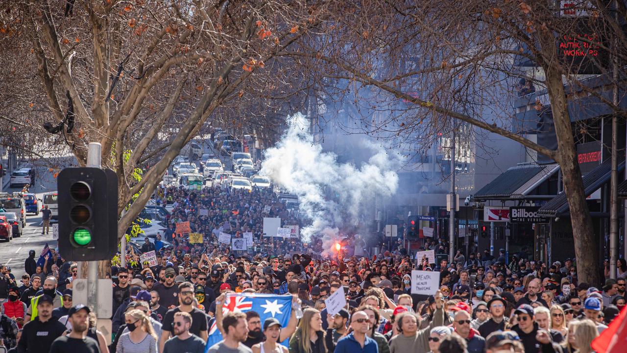 Flares were lit in Melbourne’s CBD as protesters clashed with police against Covid-19 restrictions. Picture: Jason Edwards