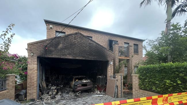 The home was significantly damaged, with a car in the garage destroyed. Picture: FRNSW