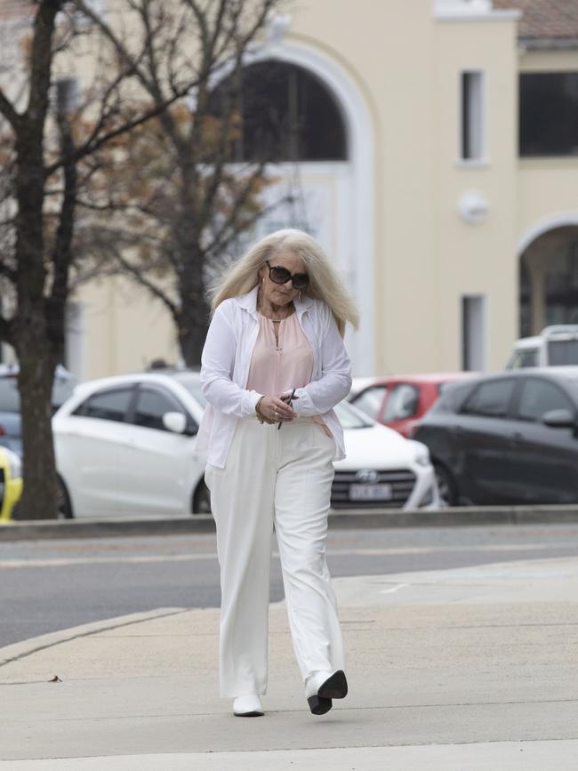 Sharon Ann Stott, 58, arrives at ACT Supreme Court during her trial over an alleged baseball bat stand over job.