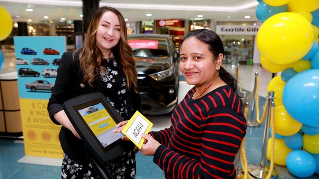 Westpoint Blacktown centre manager Agata Rynkiewicz helps shopper Dipika Bhavsar enter the car giveaway. Picture: Angelo Velardo