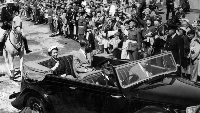 The royal white gloved hand – so familiar to thousands of Victorians – waves a friendly greeting to some of the crowd that packed Geelong streets to welcome the Queen and the Duke of Edinburgh when they visited Victoria's second largest city.