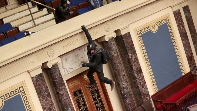 A protester is seen hanging from the balcony in the Senate Chamber. Picture: AFP