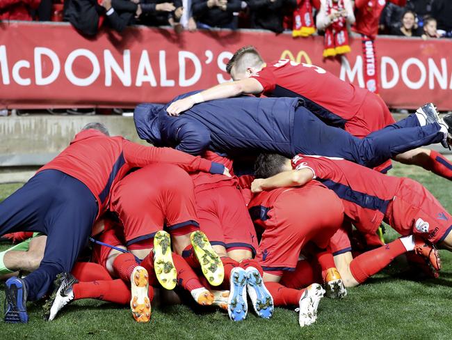 Ben Halloran and his teammates celebrate the winning goal.