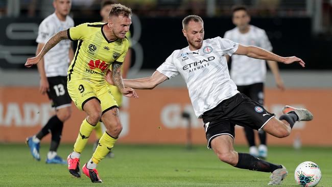 David Ball, left, of the Wellington Phoenix challenges Rostyn Griffiths of Melbourne City during their round-19 A-League match at Eden Park in Auckland on Saturday. Picture: AAP
