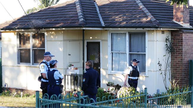 Police at the scene of a house where the two women were found dead along with a dog in Greenacre.