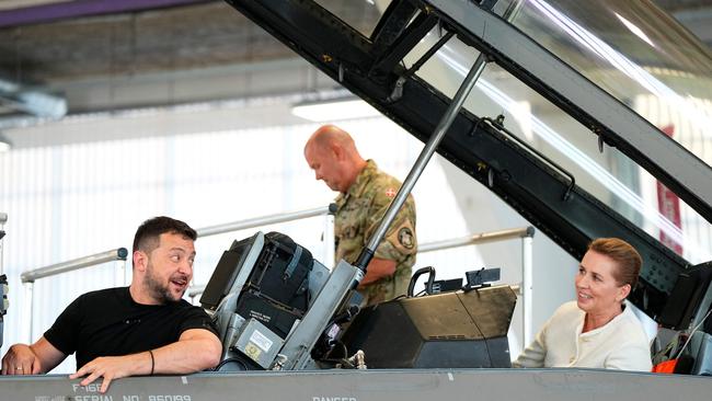 Volodymyr Zelensky and Danish PM Mette Frederiksen in an F-16 fighter jet at Skrydstrup air base in Vojens, northern Denmark, on Sunday. Picture: AFP