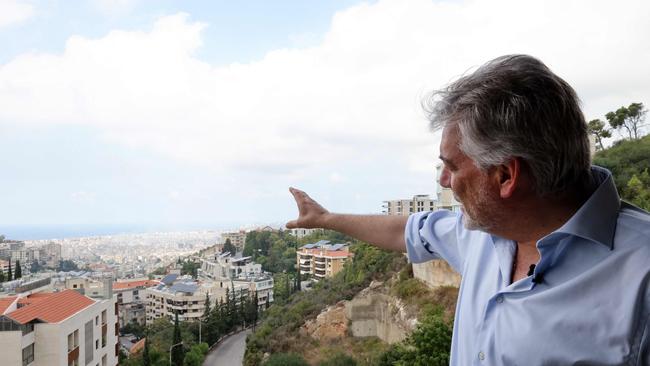 United Nations Interim Force in Lebanon spokesman Andrea Tenenti points at Beirut's southern suburbs from his office. Picture: AFP