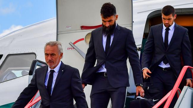 Australia football team's coach Bert van Marwijk (L) players Mile Jedinak (C) and Mat Ryan disembark from their aeroplane at Kazan airport.