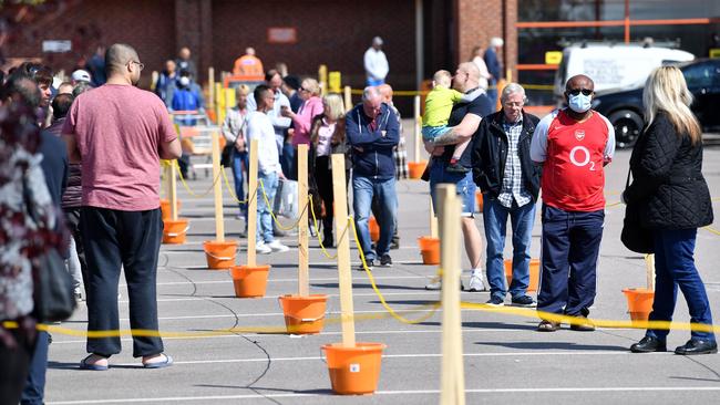 Customers adhere to social distancing guidelines as they queue to enter a B&amp;Q Warehouse, in Leicester, central England.