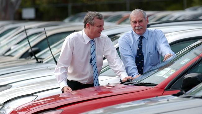 Former Premier Mike Rann and Mr Phillips at Mitsubishi’s Tonsley production plant in 2005, announcing plans to buy 200 cars for the state government fleet. Picture: Michael Rudolph