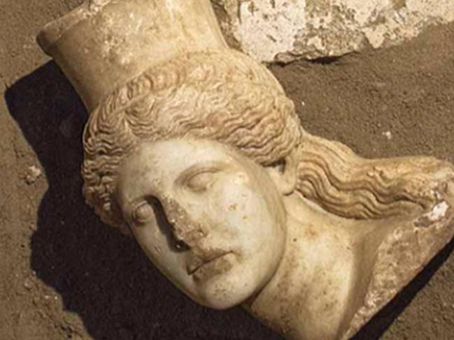 This picture provided by Greece's Culture Ministry, Oct. 20, 2014, shows the broken-off head of a marble sphinx, one of a pair that decorated the entrance of a large 4th century B.C. tomb under excavation at Amphipolis in northern Greece. Bones from a skeleton found in the tomb's innermost chamber could help solve the riddle of who was buried in opulent splendor there. A Culture Ministry statement on Wednesday, Nov. 12, 2014, said the skeleton was strewn in and around a rectangular stone-lined cist, under the floor of the cavernous, vaulted structure that is 8 metres (26 feet) tall. (AP Photo/Greek Culture Ministry)