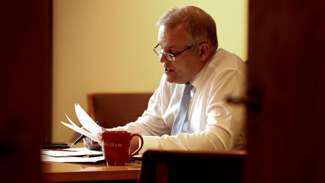 Australian Prime Minister Scott Morrison works in his office at Parliament House in Canberra. Picture: Adam Taylor/PMO