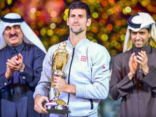 Novak Djokovic of Serbia celebrates with his trophy after winning the Qatar ExxonMobil Open. Picture: Alexandra Panagiotidou