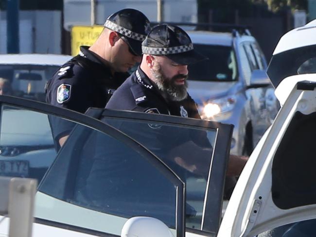 Police searching through a car on the Gold Coast Highway at Miami. Picture Glenn Hampson