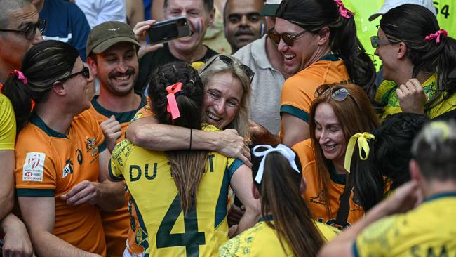 Australia's Dominique Du Toit celebrates with relatives after her side’s pool B rugby sevens win against South Africa. Picture: AFP