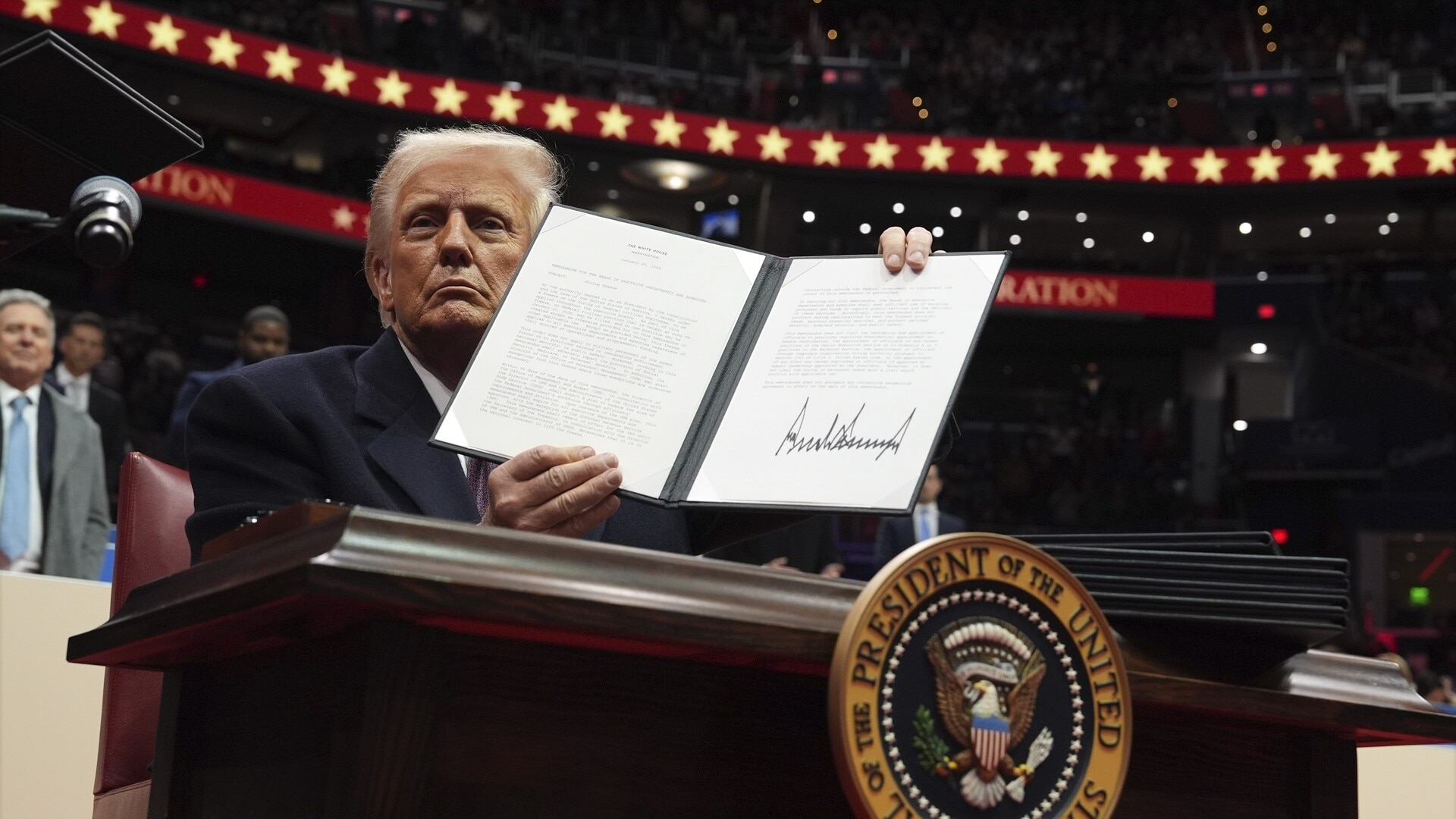 Donald Trump signs executive orders at inauguration parade