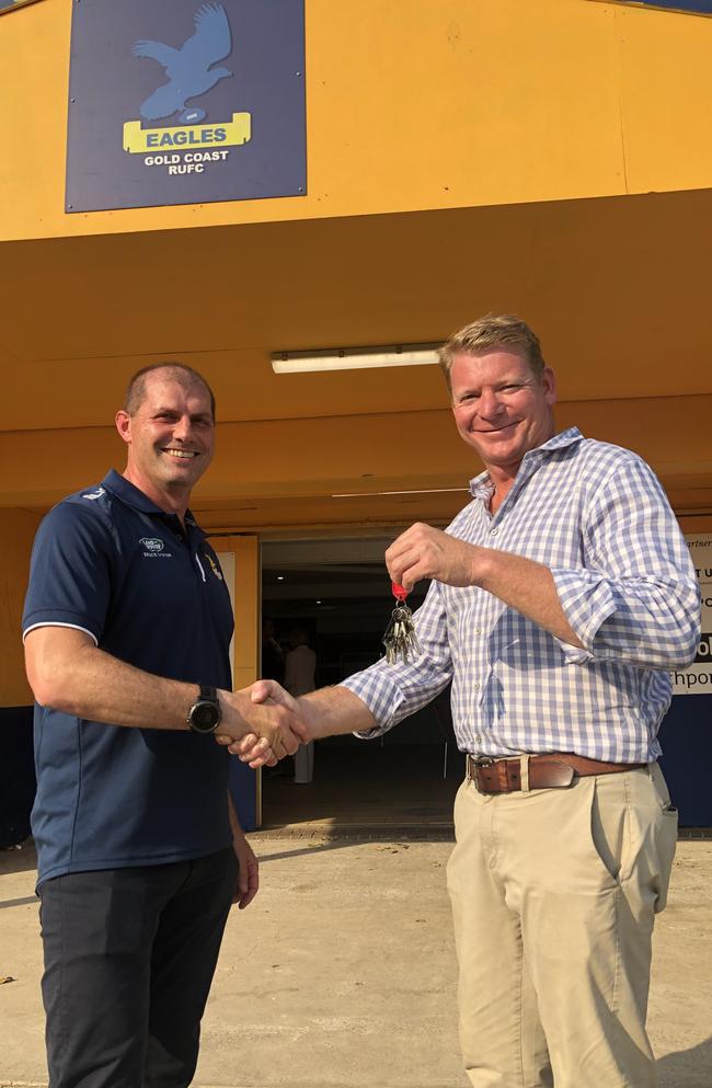 Outgoing Gold Coast Eagles president Ben Latimer hands keys to the club to incoming president Jason Terens. Picture: Supplied