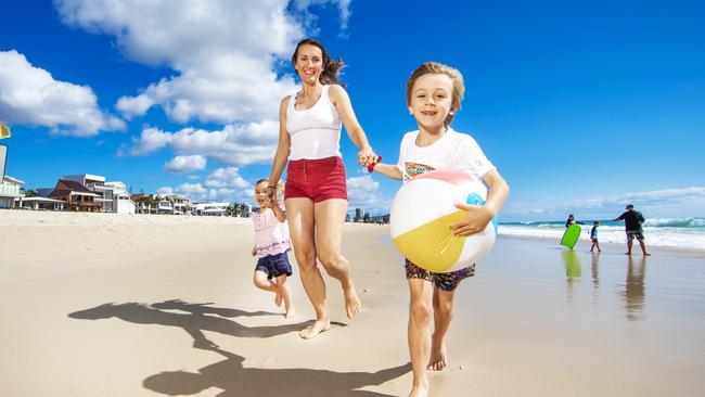 Petra Nowak with her children Peter, 6 and Mira, 2 relax at Palm Beach. Picture: Nigel Hallett