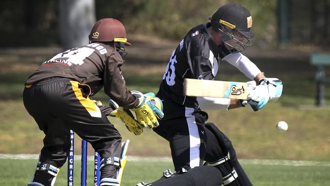 Adelaide University’s Will Bosisto in action with Kensington wicket keeper Tom van der Jeugd. Picture: AAP/Dean Martin