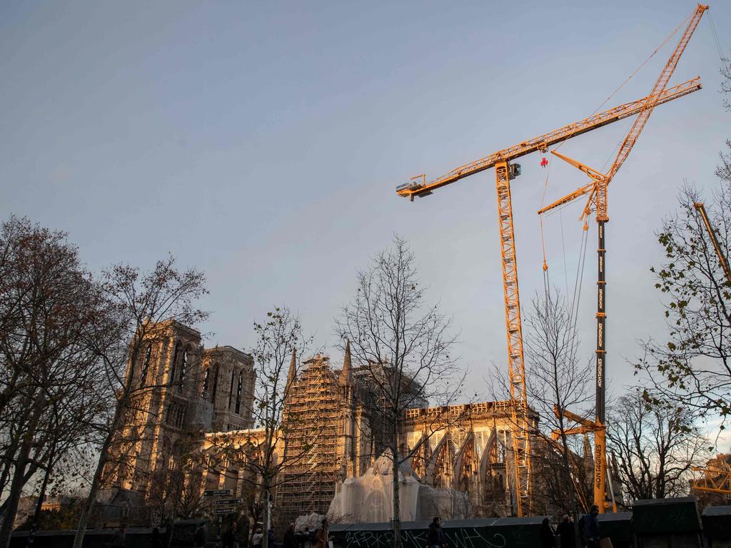 Cranes outside the Notre-Dame Cathedral in Paris, which was partially destroyed when fire broke out beneath the roof on April 15, 2019. Picture: Thomas SAMSON / AFP