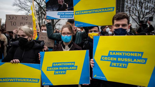 Pro-Ukraine demonstrators display placards during a demonstration in front of the Russian embassy in Berlin. Picture: John MACDOUGALL/AFP