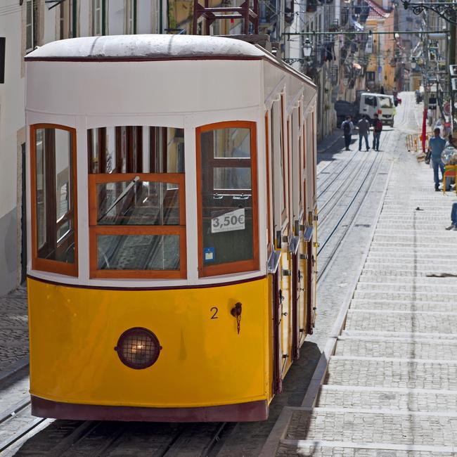 Traditional yellow tram in Barrio Alto, Lisbon, Portugal.