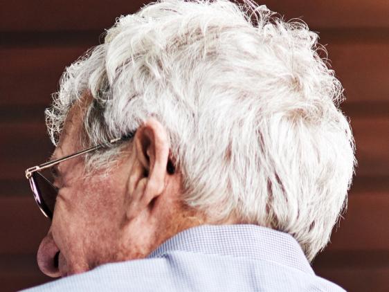 Shot of a young nurse helping a senior man with a walker