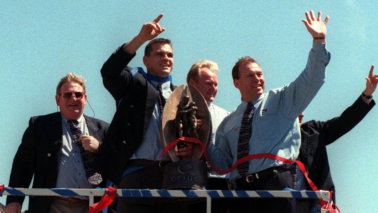 Crowds cheer Newcastle captain Paul Harragon and coach Malcolm Reilly during the tickertape parade in Newcastle to celebrate the Knights win in the 1997 ARL grand final.