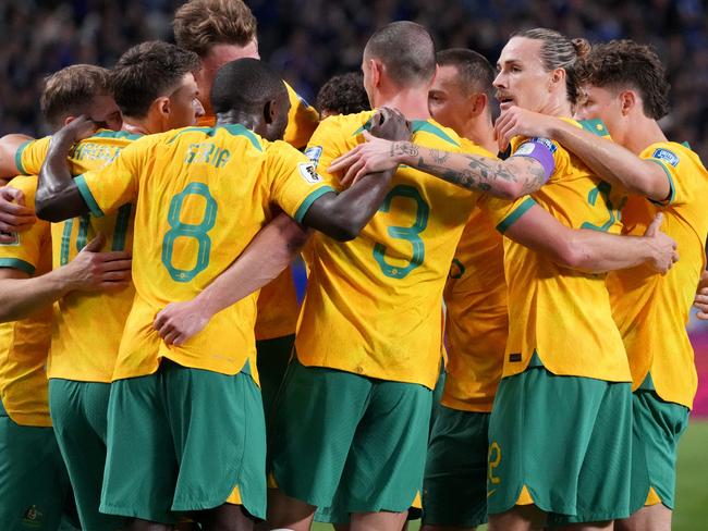 SAITAMA, JAPAN - OCTOBER 15: Australia players celebrate after Shogo Taniguchi of Japan (not pictured) scores an own goal to make it the first goal for Australia during the FIFA World Cup Asian Third Qualifier Group C match between Japan and Australia at Saitama Stadium on October 15, 2024 in Saitama, Japan.  (Photo by Koji Watanabe/Getty Images)