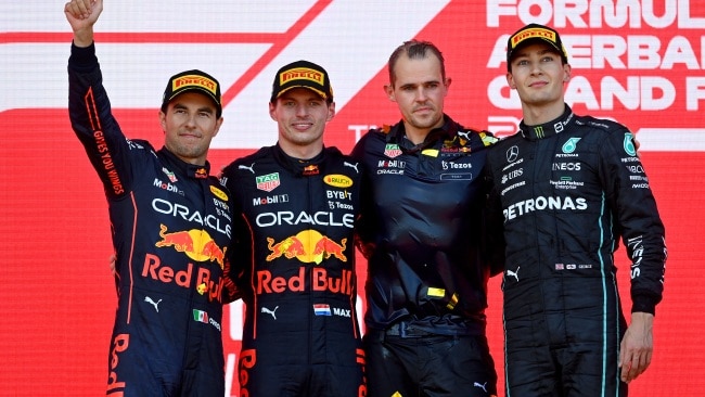 Max Verstappen celebrates his win in Azerbaijan on the podium with Sergio Perez and George Russell. (Photo by Dan Mullan/Getty Images)