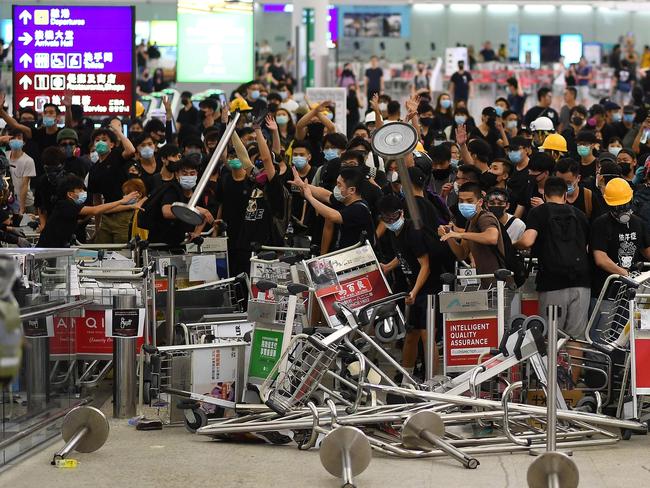 Pro-democracy protesters block the entrance to the airport terminals after a scuffle with police at Hong Kong's international airport on August 13. Picture: AFP