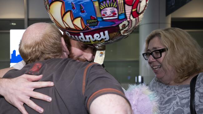 They were one of the emotional reunions seen at Sydney’s Kingford Smith Airport on Tuesday night. Picture: NCA NewsWire / Monique Harmer