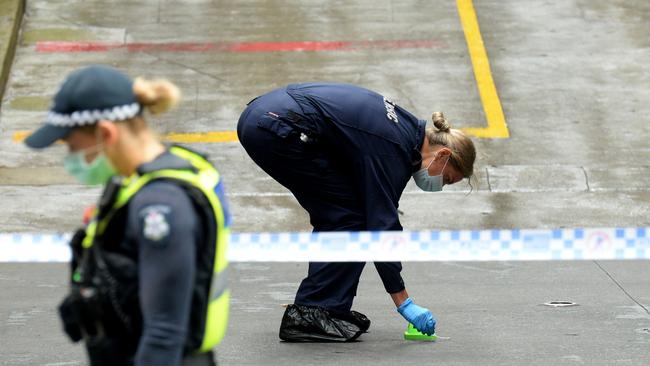 Police at an apartment building on Spencer Street. Picture: Andrew Henshaw