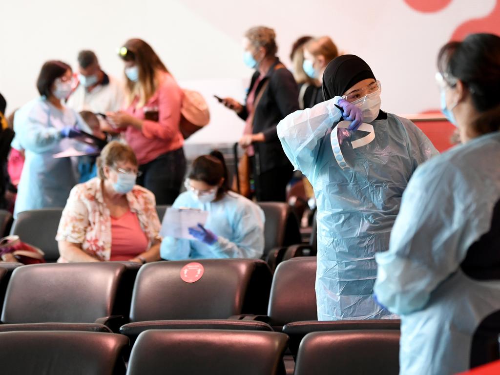 Returning passengers from Brisbane are screened at the arrivals gate in the Qantas Terminal at Sydney airport. Picture: NCA NewsWire / Jeremy Piper