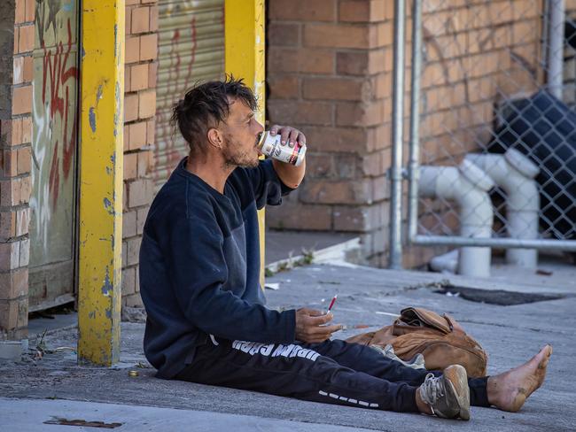 The man drinks alcohol in the alley. Picture: Jason Edwards