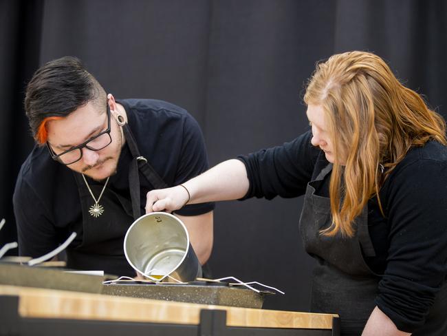 Troublesmiths volunteers Brayden Price and April Duffey making candles. Picture: RICHARD JUPE