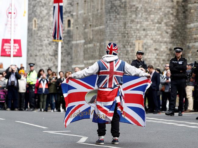 Royal super fan John Loughery walks with a Union flag outside Windsor Castle. Picture: AFP