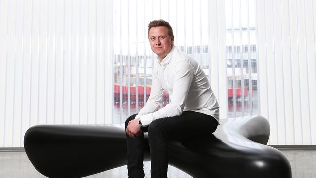 Hobart born designer Brodie Neill who is now based in London. He is pictured with furniture he designed in the new Brooke Street Pier.