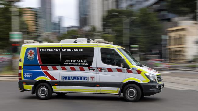 MELBOURNE, AUSTRALIA - NewsWire Photos FEBRUARY 13, 2022: An ambulance speeds away from the Royal Melbourne Hospital. Ambulance, Generic.Picture: NCA NewsWire / David Geraghty