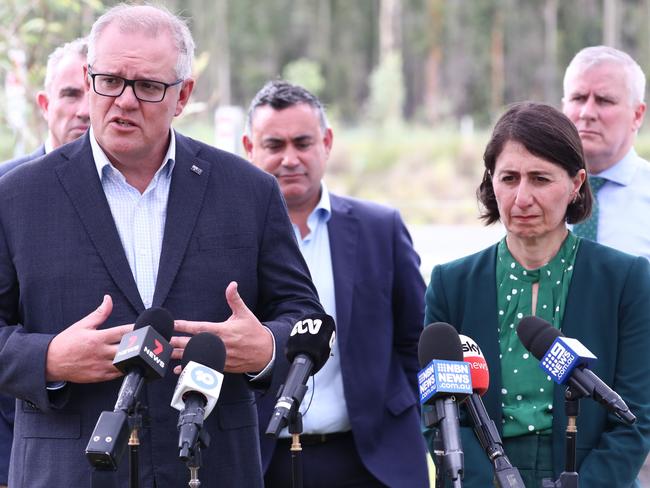 Prime Minister Scott Morrison ( C ) , Deputy Prime Minister Michael McCormack and NSW Premier Gladys Berejiklian inspect a section the NSW Pacific Highway at New Italy, outside Ballina, NSW, Thursday , December 17 , 2020. (AAP Image/Jason O'Brien) NO ARCHIVING